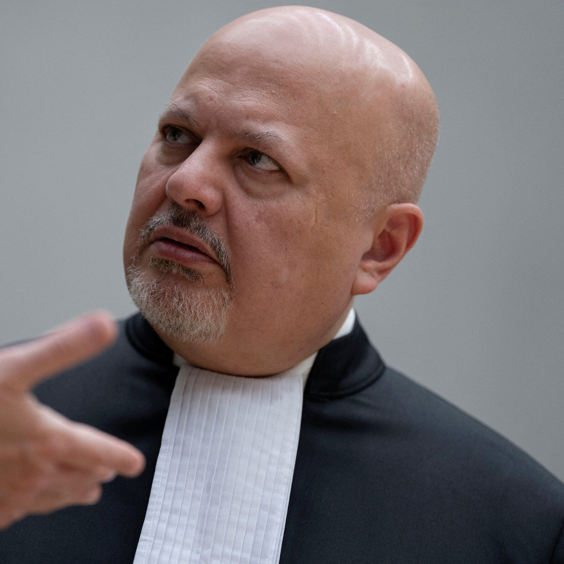 A former senior commander of a Gaddafi-era Libyan prison, accused of overseeing systematic torture, murder and rape of inmates — sometimes in front of their children — appeared before the International Criminal Court on 20 May 2026.